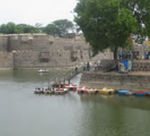 Local lake with small boats docked along a rock wall