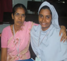 A nun and volunteer smiling for the camera