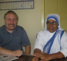 Richard Groves sitting with a nun in India