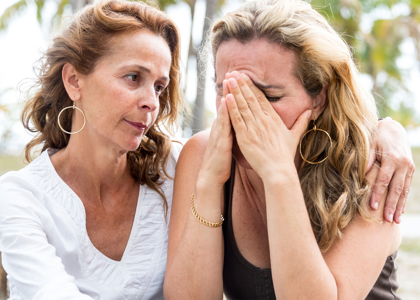 One woman consoling another who is crying